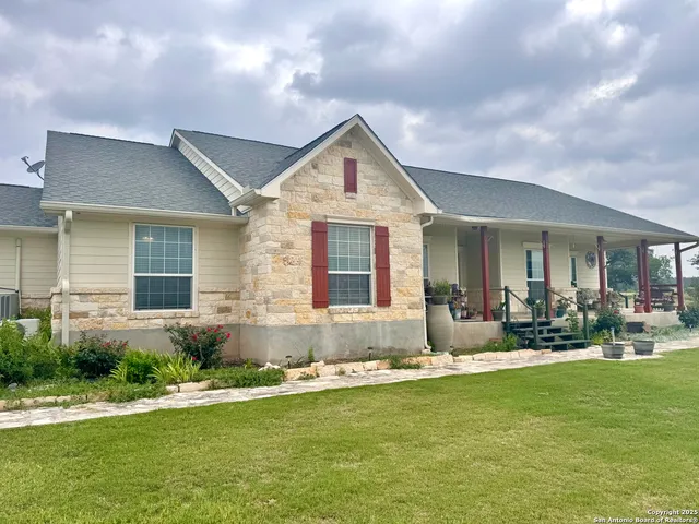 a front view of house with yard and outdoor seating