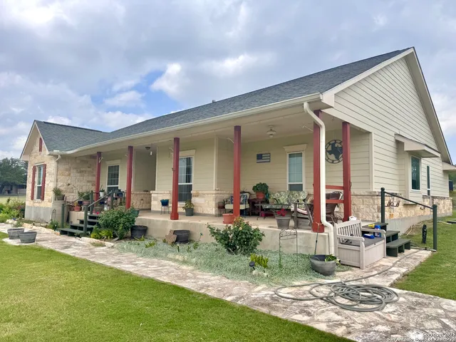 a front view of house with yard patio and outdoor seating