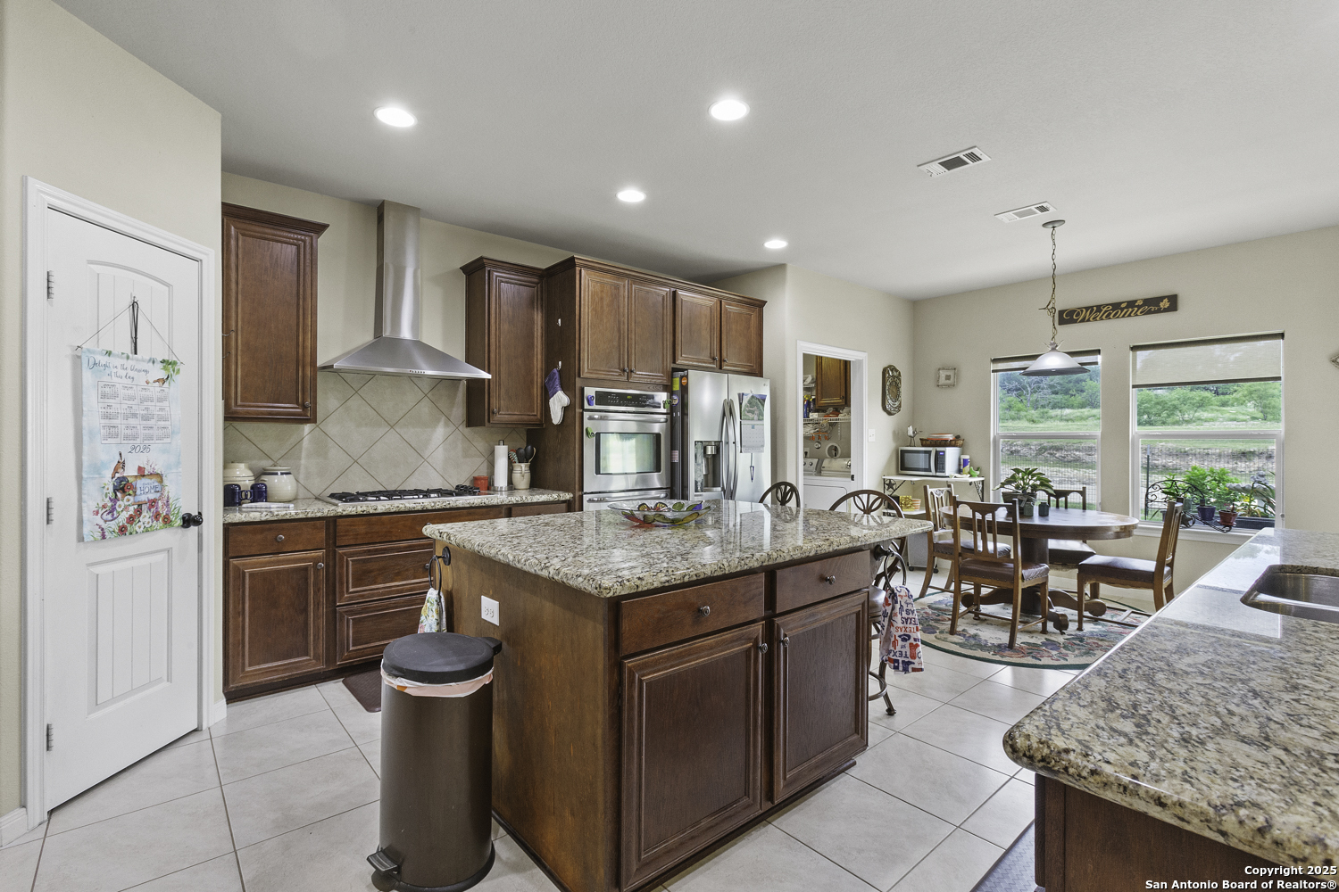 187 Tracks Center Point, TX 78010 - Photo 10 of 42 a kitchen with stainless steel appliances granite countertop a stove top oven a sink dishwasher and cabinets with wooden floor