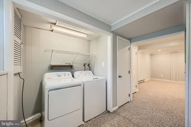 a view of storage and utility room with washer and dryer