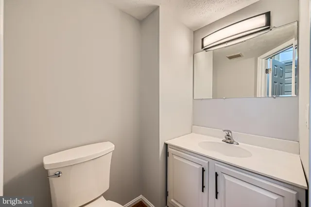 a bathroom with a sink toilet and a mirror