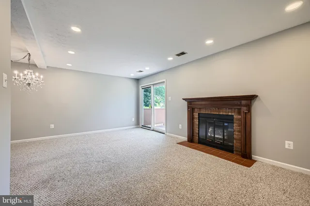 a view of an empty room with a fireplace