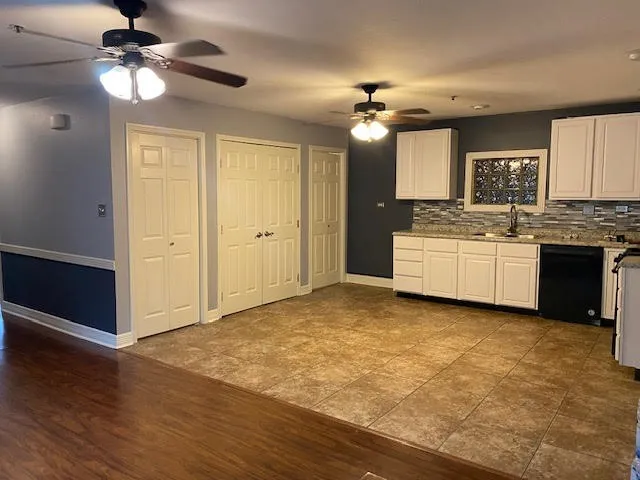 a view of a kitchen with a sink and a chandelier fan