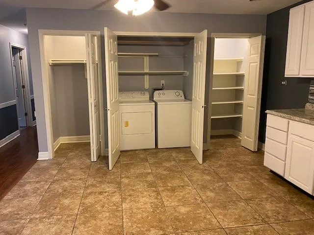 a view of an empty room with cabinet and a window
