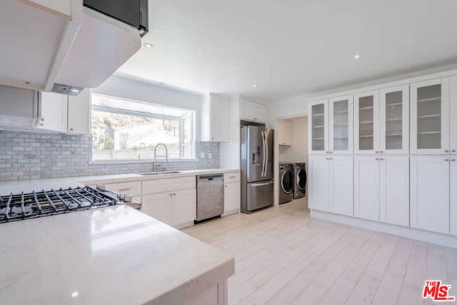 a kitchen with refrigerator and window