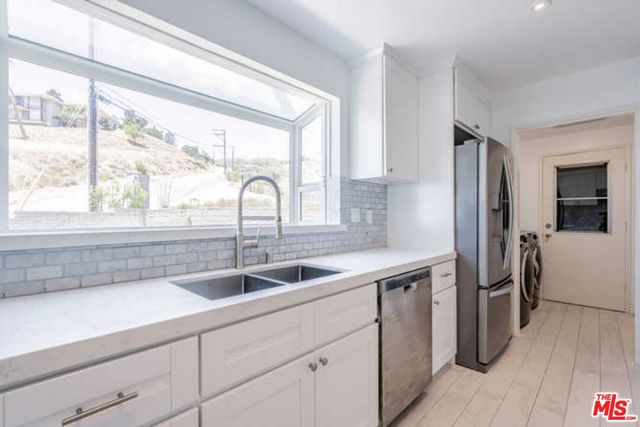 a kitchen with a sink and refrigerator