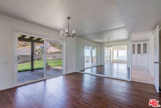 a view of an entryway with wooden floor