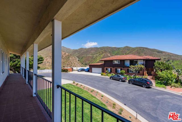a view of a street with a large trees