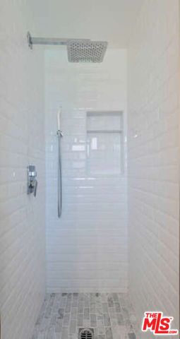 a bathroom with a glass shower door