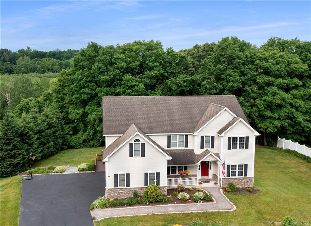 82 Long Meadow Hill Road Brookfield, CT 06804 - Photo 1 of 1 a view of a white house next to a yard with plants and large trees
