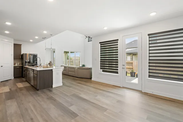 a view of kitchen with microwave and refrigerator