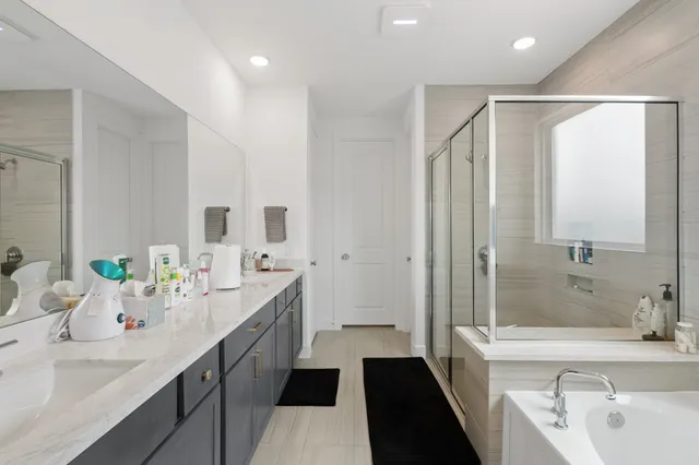 a bathroom with a double vanity sink mirror double and shower