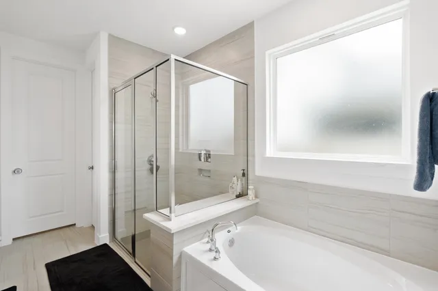 a bathroom with a tub and a shower