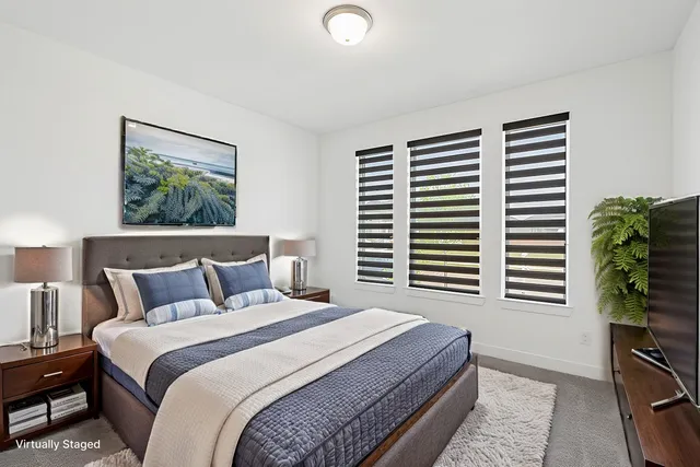 a bedroom with a bed and a painting on the wall