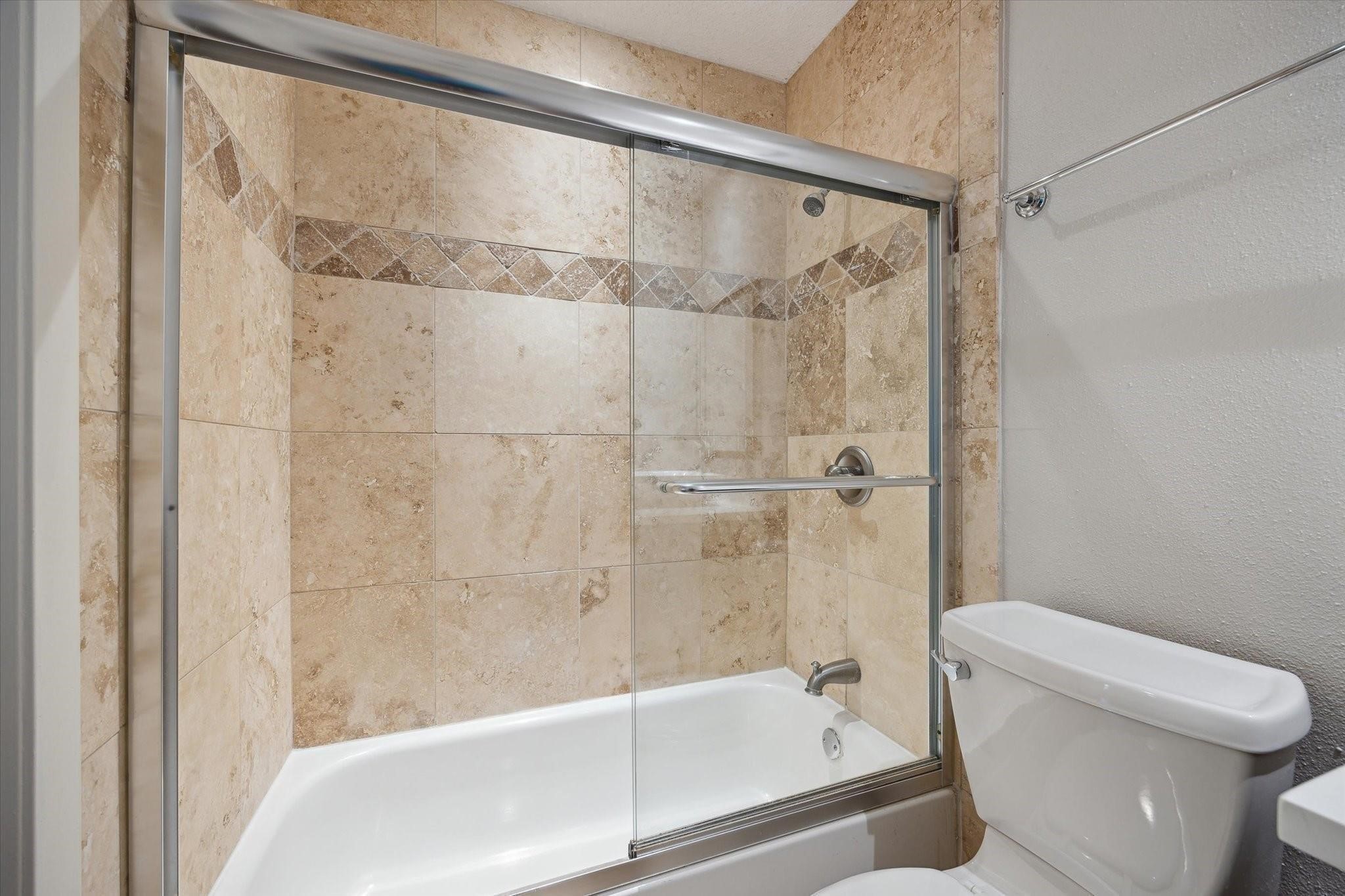 3616 Ocee Street Houston, TX 77063 - Photo 9 of 12 a bathroom with a shower and a toilet