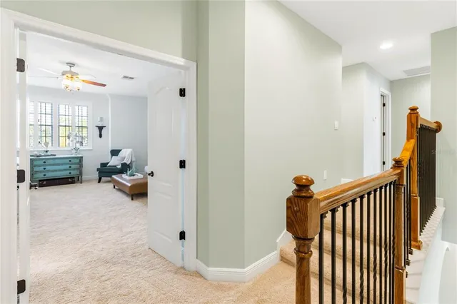 a view of a hallway to a livingroom and a livingroom with furniture