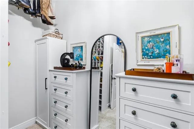 a view of hallway with mirror and dresser