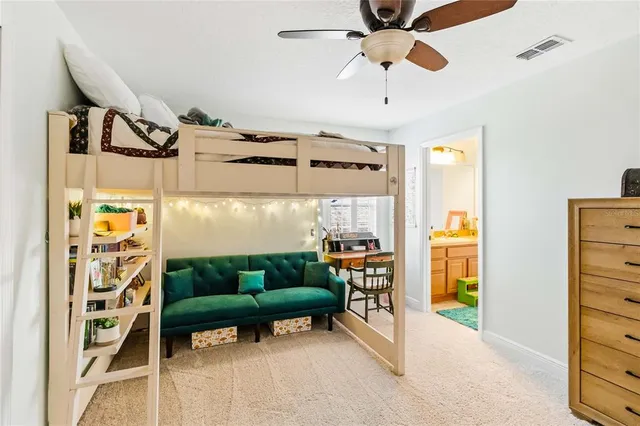 a living room with furniture a ceiling fan and a window