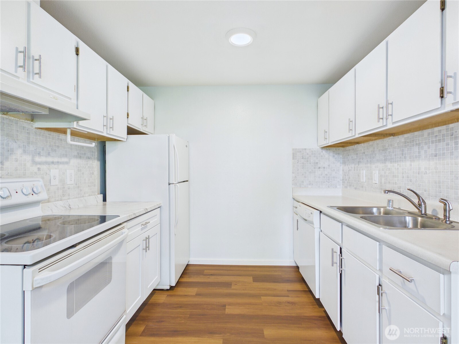 11002 Southeast Petrovitsky Road, Unit I102 Renton, WA 98055 - Photo 6 of 24 a kitchen with granite countertop a sink and cabinets