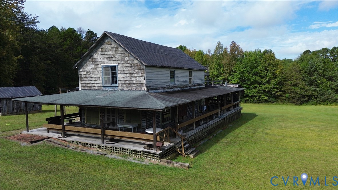 7246 MacDonald Road Scottsburg, VA 24589 - Photo 11 of 46 a view of backyard of house with outdoor seating and green space