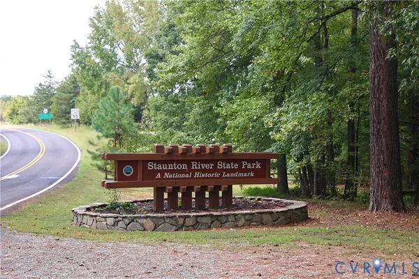 a wooden bench sitting in the middle of a park