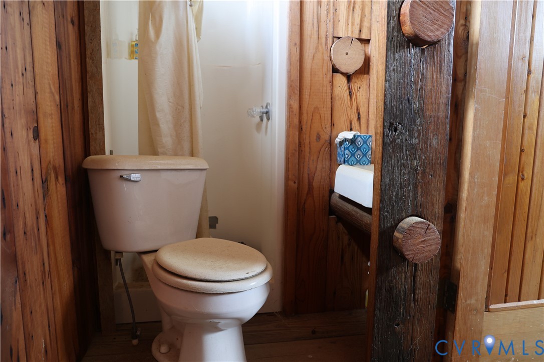 7246 MacDonald Road Scottsburg, VA 24589 - Photo 35 of 46 a bathroom with a toilet and a shower curtain