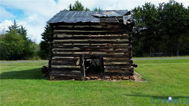a view of a green field with a tree