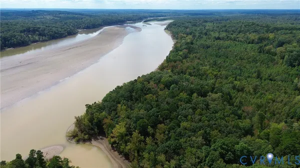 an aerial view of a house with a yard and lake view