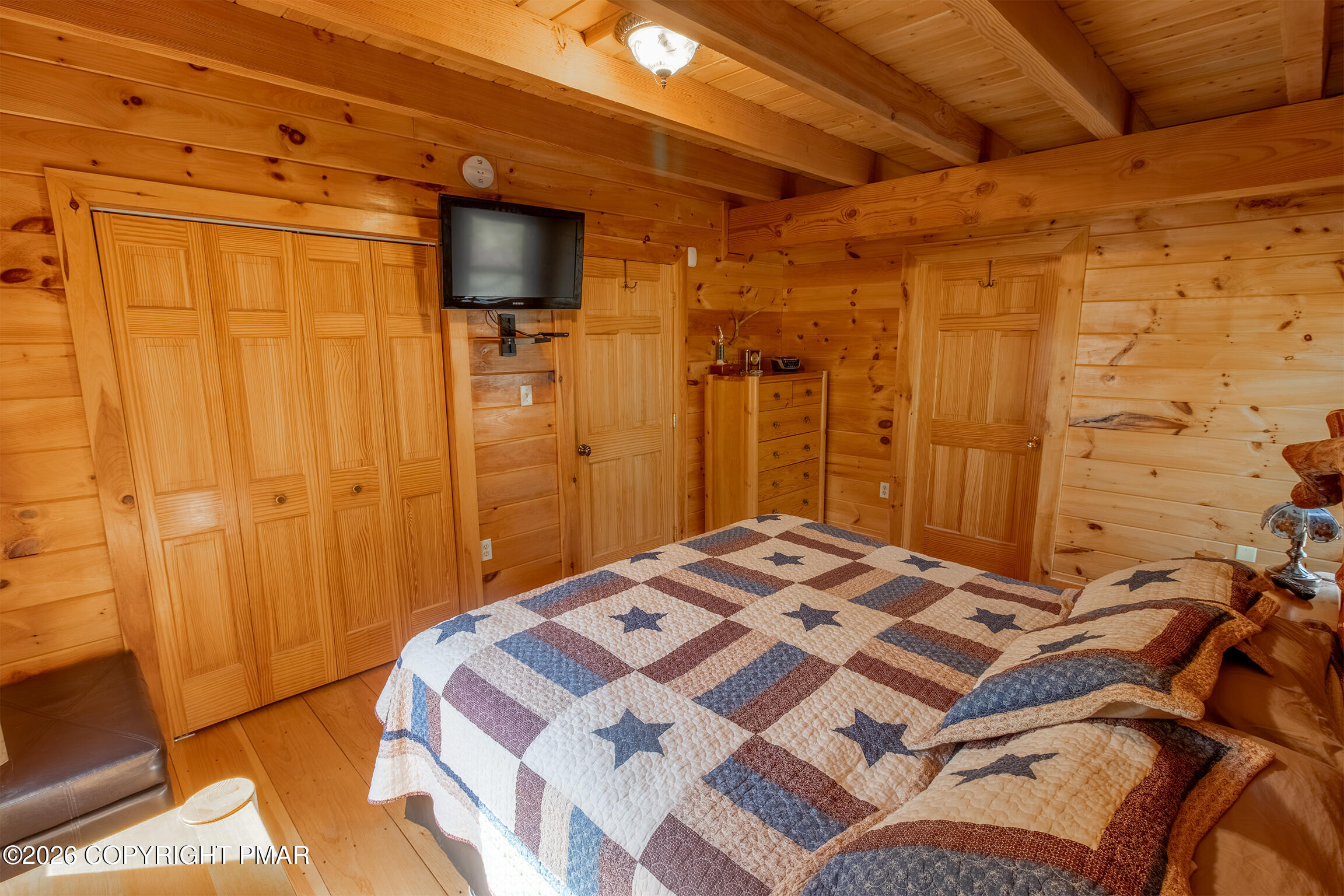 1160 Bluebird Lane Bushkill, PA 18324 - Photo 28 of 44 a bedroom with a bed and a chandelier