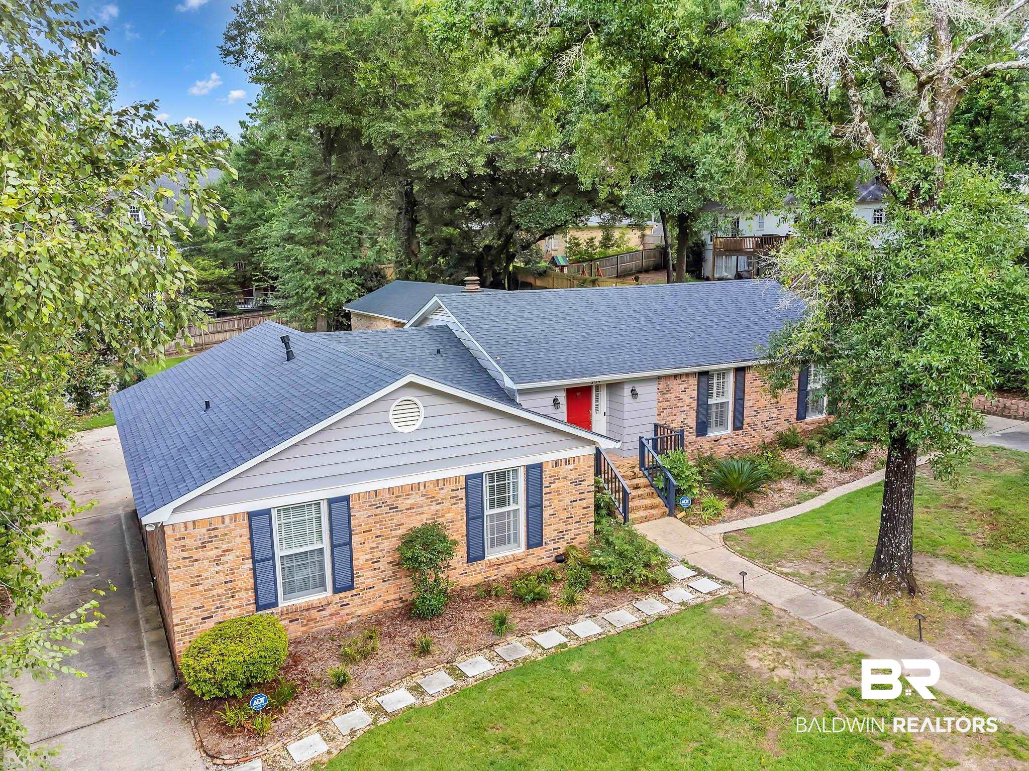 309 West Brandy Run Road Mobile, AL 36608 - Photo 93 of 100 Ranch-style house with a front yard, brick siding, a shingled roof, and view of wooded area