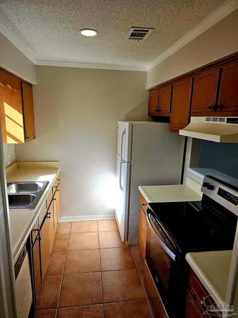 a kitchen with stainless steel appliances a stove a sink and a refrigerator