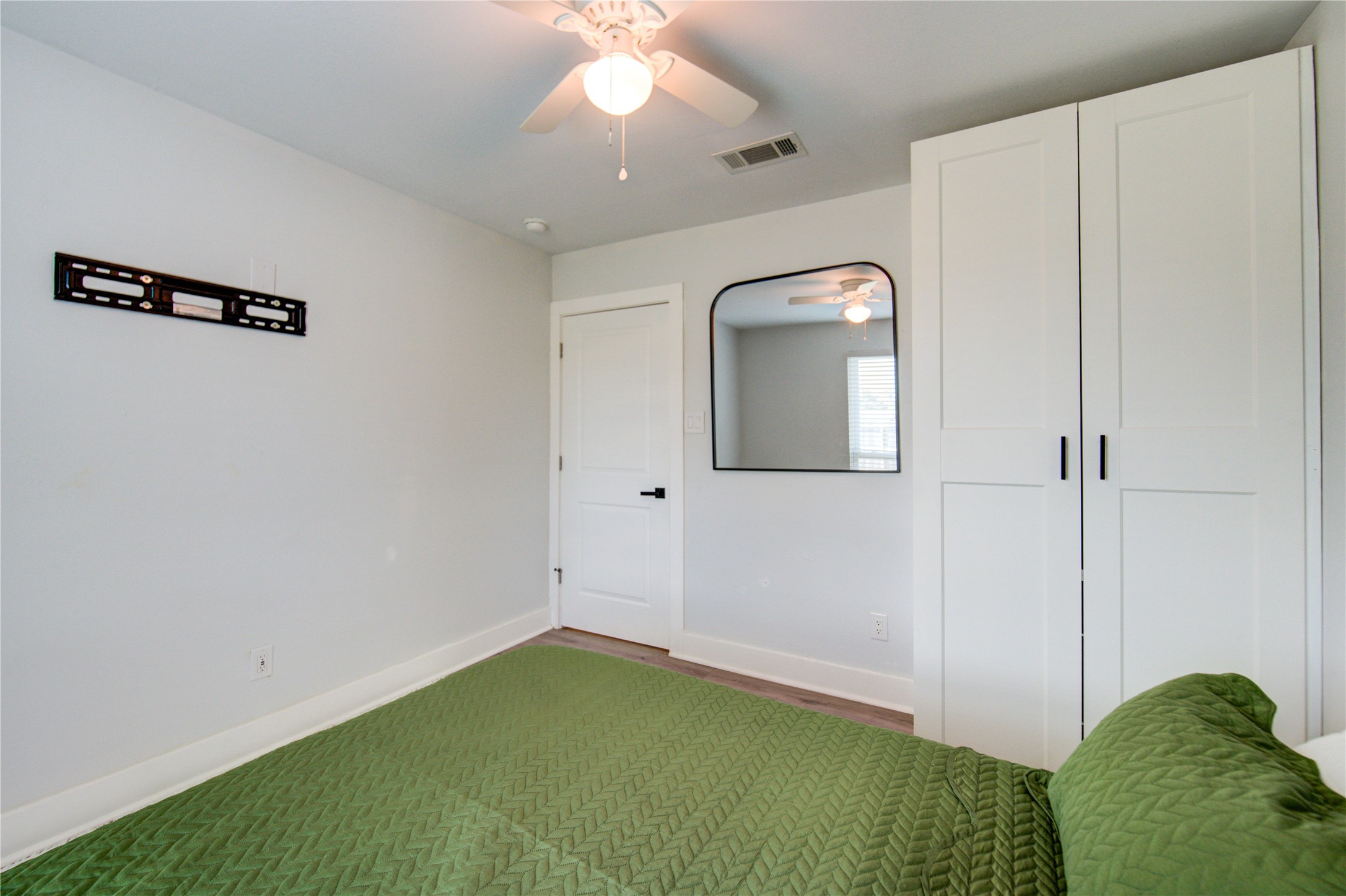 4049 Lucille Street, Unit B Houston, TX 77026 - Photo 8 of 13 a view of a room with bed and mirror