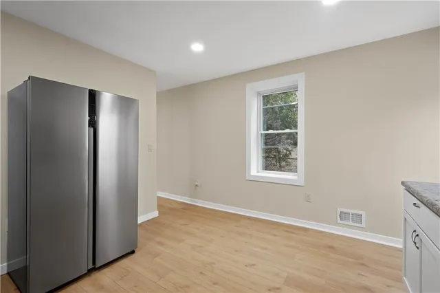 an empty room with windows and closet