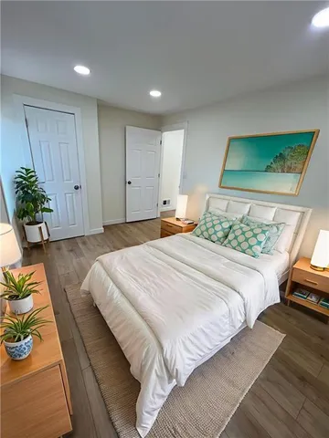 a bedroom with a bed and a couch