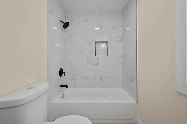 a bathroom with a bathtub and a toilet