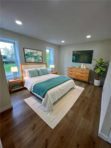 a bedroom with a bed and a couch