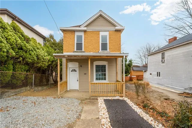 a view of a brick house with large windows