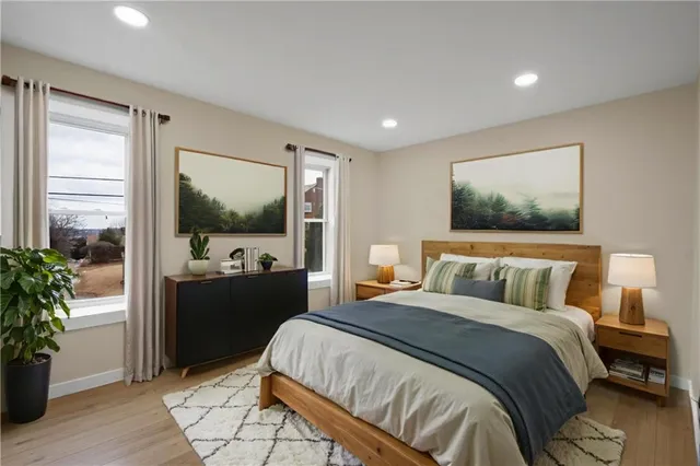 a bedroom with a large bed and a flat screen tv