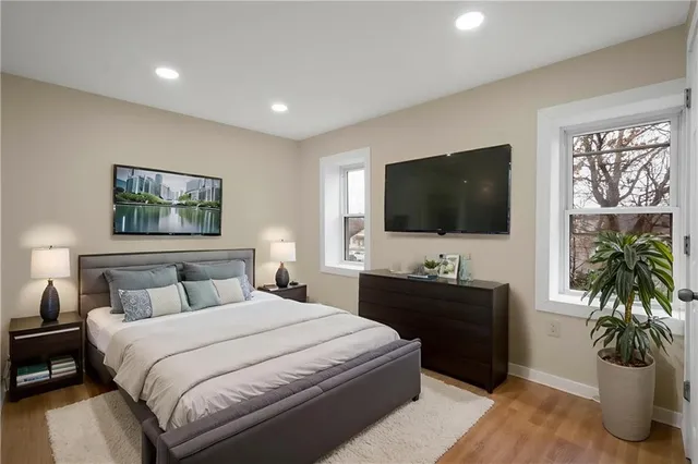 a bedroom with a bed and a flat screen television