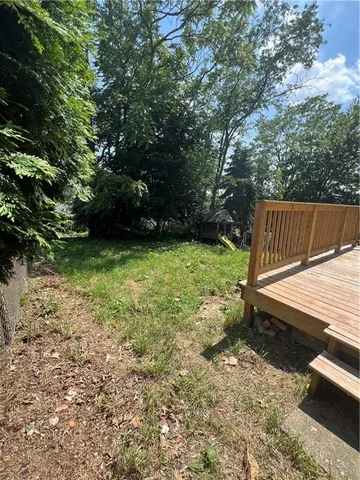 a view of a backyard with chairs and a table
