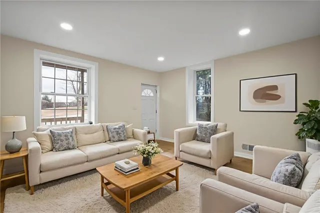 a living room with furniture and a large window