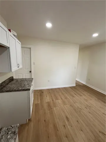 a view of a kitchen with wooden floor and a sink
