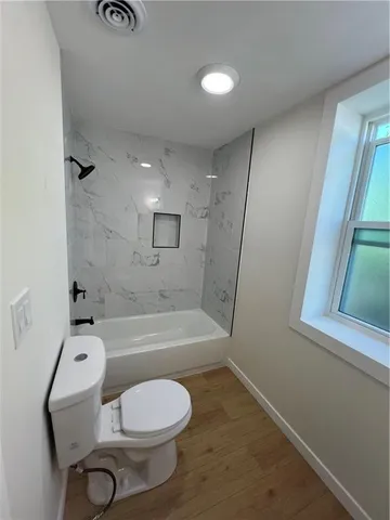 a bathroom with a toilet sink and bathtub