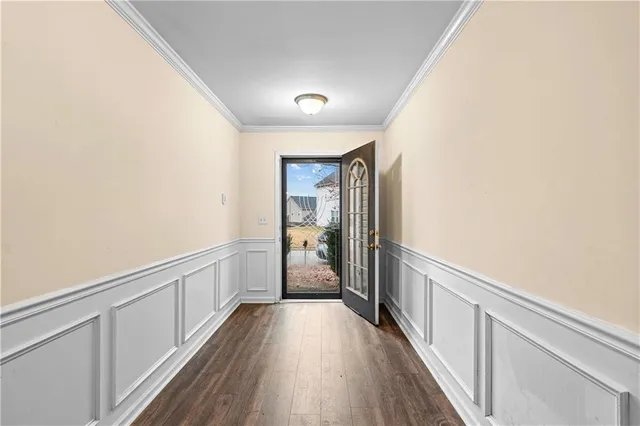 a view of hallway with wooden floor