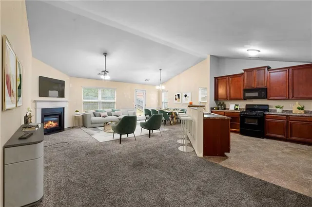 a living room with furniture a fireplace and a television