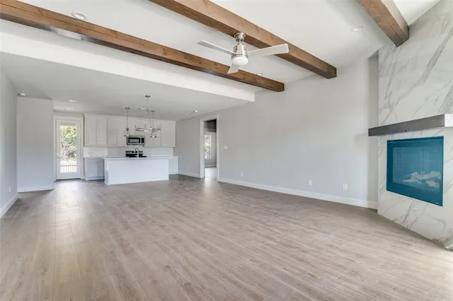 a view of a living room a kitchen and a wooden floor