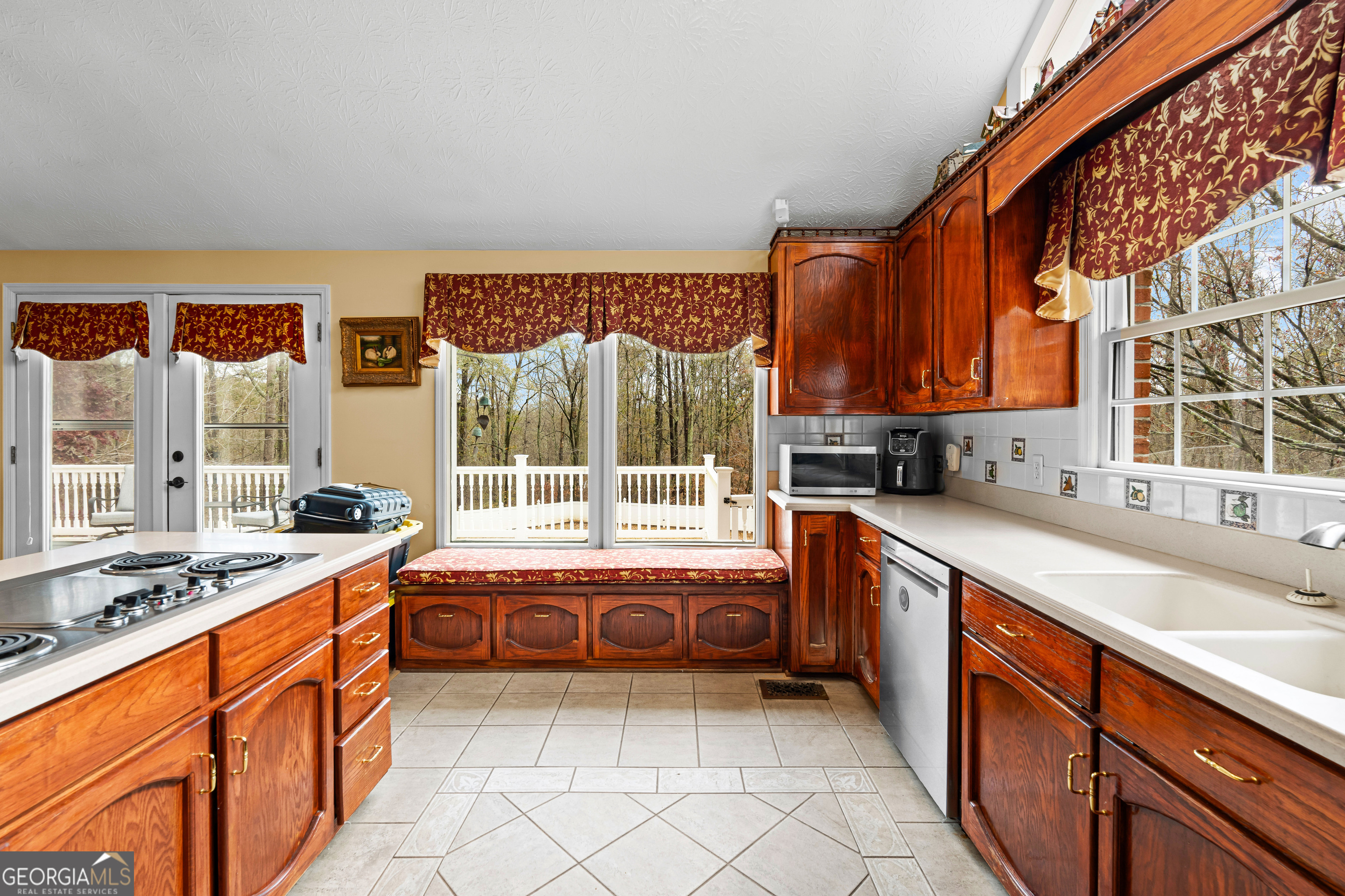 296 Ebenezer Church Road Fayetteville, GA 30215 - Photo 12 of 66 a large kitchen with stainless steel appliances granite countertop a sink and a stove