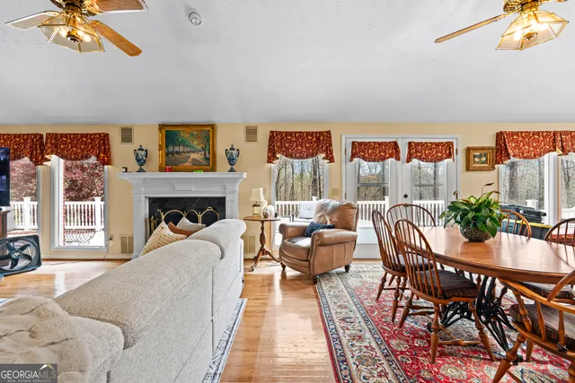 a living room with furniture and a floor to ceiling window