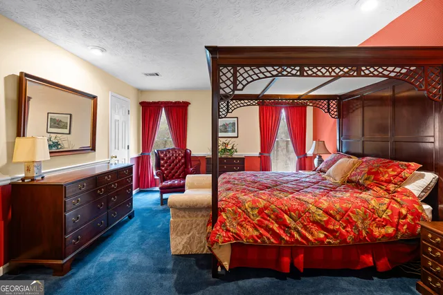 a dining room with wooden floor a chandelier fan a glass table and chairs