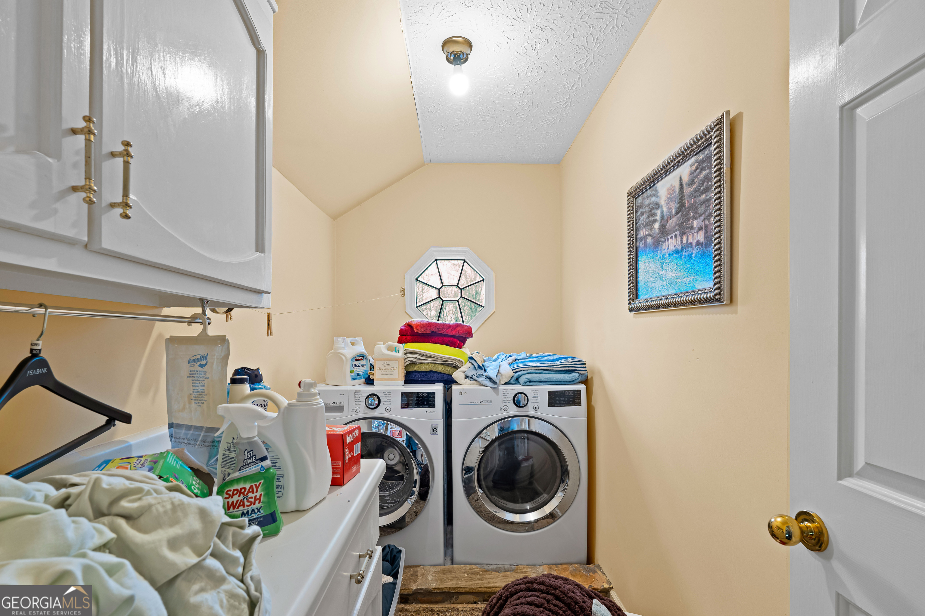 296 Ebenezer Church Road Fayetteville, GA 30215 - Photo 28 of 66 a utility room with dryer washer and a view of living room